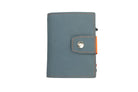 Closed Garzini Metal Wallet in blue leather with orange strap and snap button, minimalist design with push button
