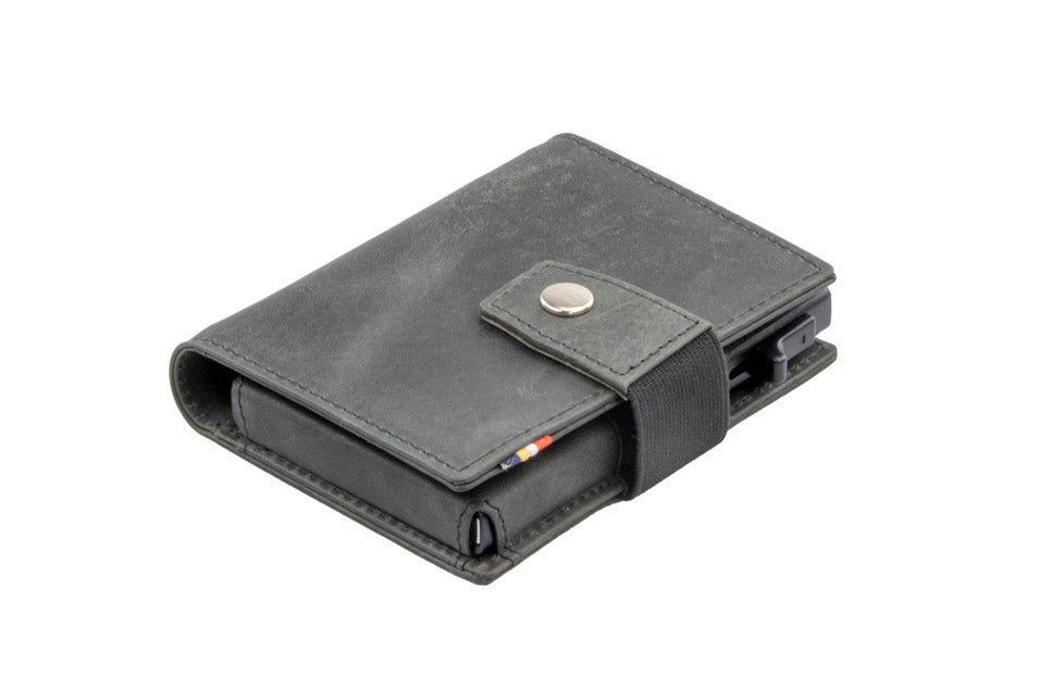 Closed Garzini Metal Wallet in brushed black leather with push button, viewed from an angle
