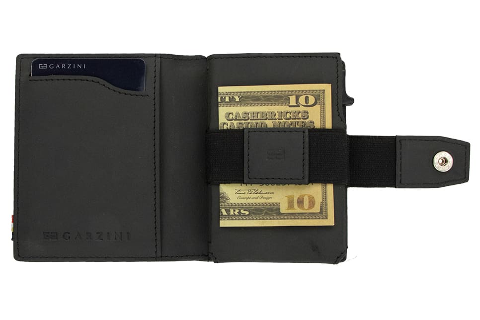 Open Garzini Metal Wallet in carbon black leather, holding a stack of cash