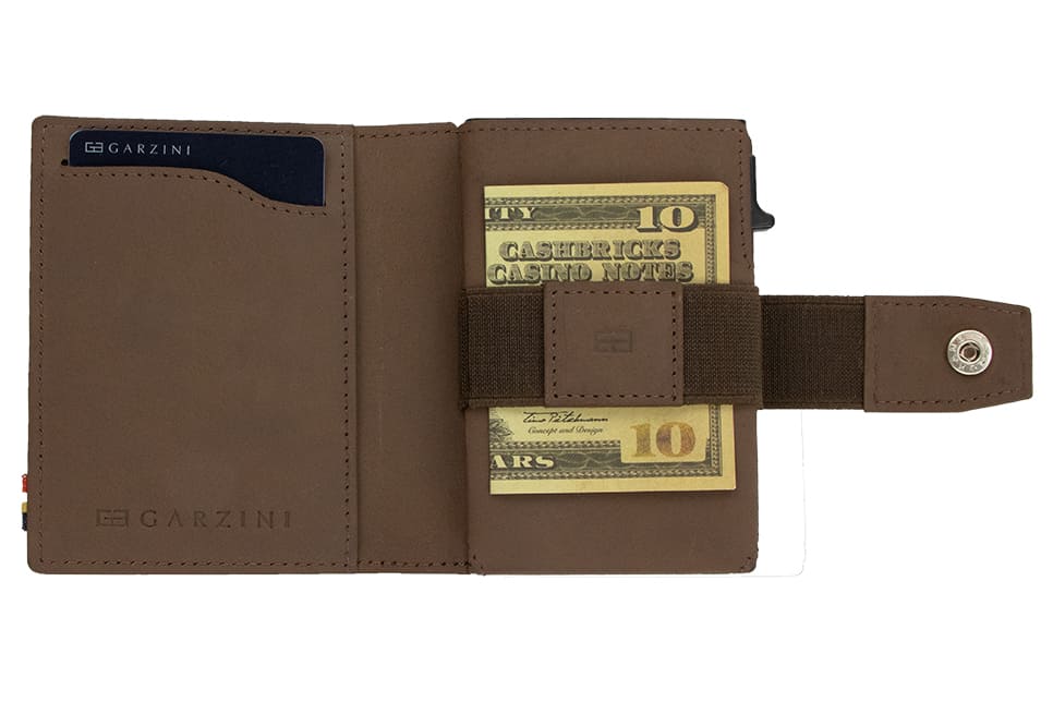 Open Garzini Metal Wallet in java brown leather, holding a stack of cash
