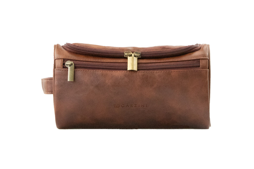 Close-up of Brown Garzini Toiletry Bag front side, highlighting high-quality vegan leather and durable zipper.